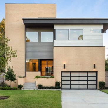 Dusk photo of 3851 Merrick St, a modern blonde brick two-story home in Braes Heights, Houston, built by Scale Design+Build
